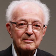 Portrait de M. Bourgeault : cheveux blancs, lunettes subtiles, air jovial même sans sourire.